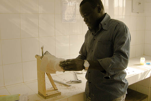 A technician grinds away at a plaster leg cast at the Physical Rehabilitation Reference Centre in Juba, South Sudan